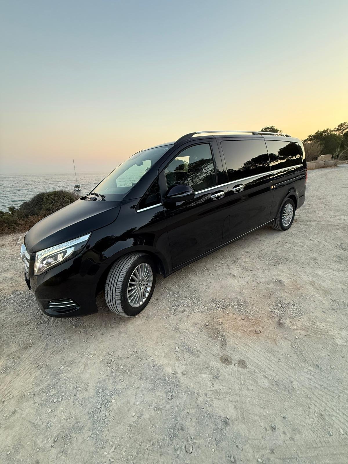 Mercedes V-Class chauffeur van, Ibiza coastline at sunset